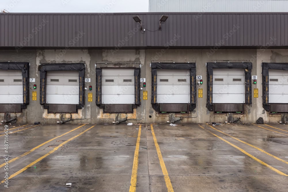 A photo showing a warehouse loading dock with closed garage doors, highlighting open perimeter
