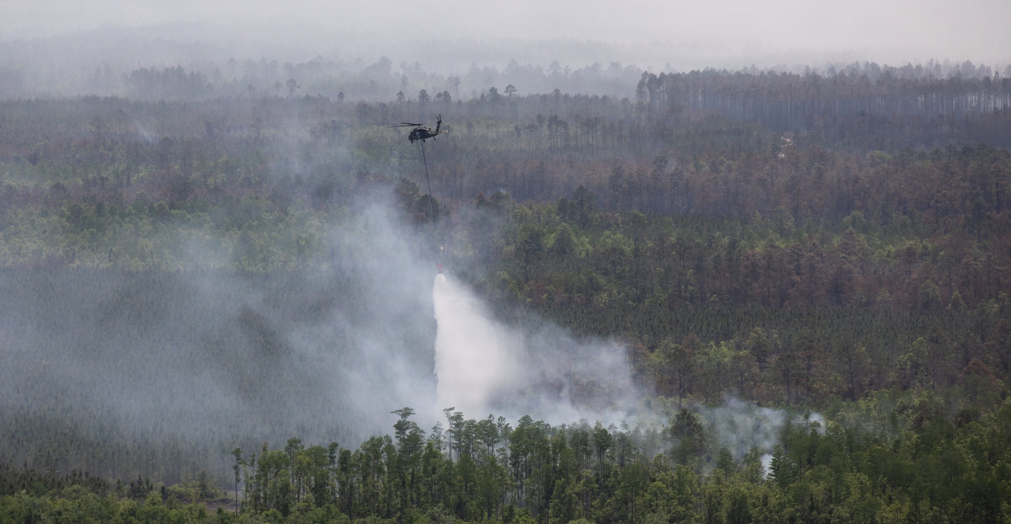 Georgia Army National Guard, drops water on an active fire during the wildfire suppression efforts in Pineland, Georgia, April 25, 2026. Photo by Sgt. Jordan McNeal.
