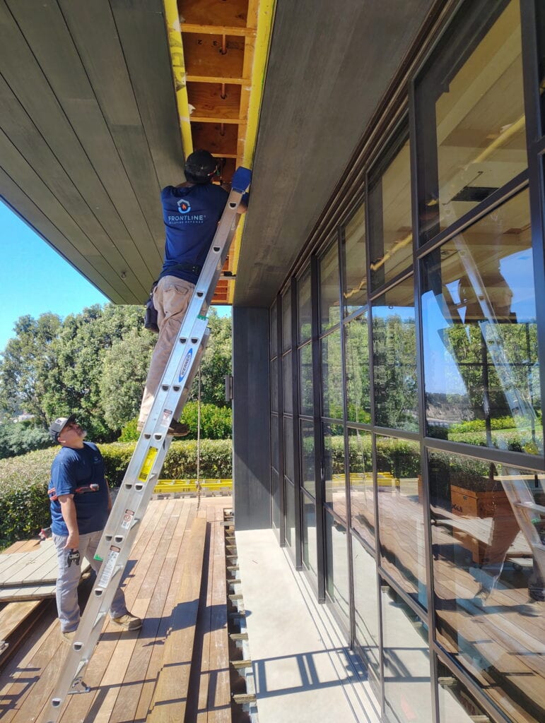 Certified Partner Installers from Self Made Construction installing eaves sprinklers at a client home.