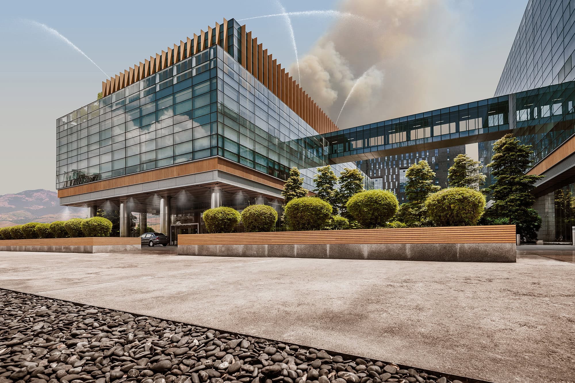 A photo showing the exterior of a business complex while Frontline’s commercial wildfire defense system sprays water around the full perimeter of the building.