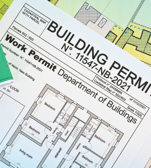 Architectural floor plan blueprints alongside an official Department of Buildings work permit document.